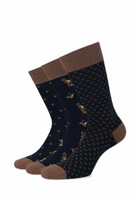 Trzy pary ciemnoniebieskich skarpetek z brązowymi mankietami. Jedna z nich ma wzór małych postaci, podczas gdy pozostałe mają kropkowane i geometryczne wzory.