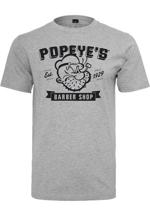 T-shirt en coton gris avec un design graphique d'un personnage de dessin animé tenant une pipe et le texte "POPEYE'S BARBER SHOP" établi en 1929.