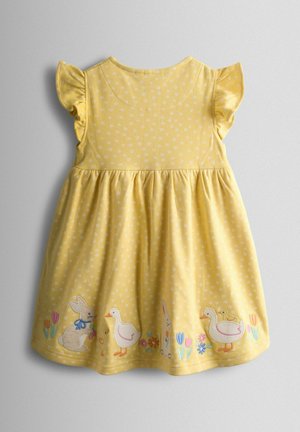 Dzeltena kokvilnas kleita ar baltām punktiņām, volāna piedurknēm un izšūtiem trusīša un pīles motīviem pie apakšmala. Gluda tekstūra un rotaļīgs dizains.