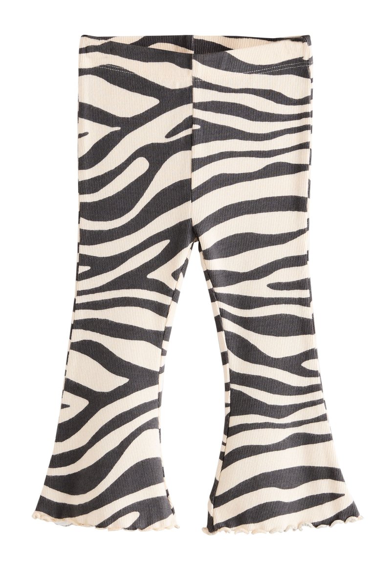 Sorte og cremefarvede zebra-mønstrede leggings med vidde, ribbet tekstur og flæsekanter nederst, med en tætsiddende taljebånd.