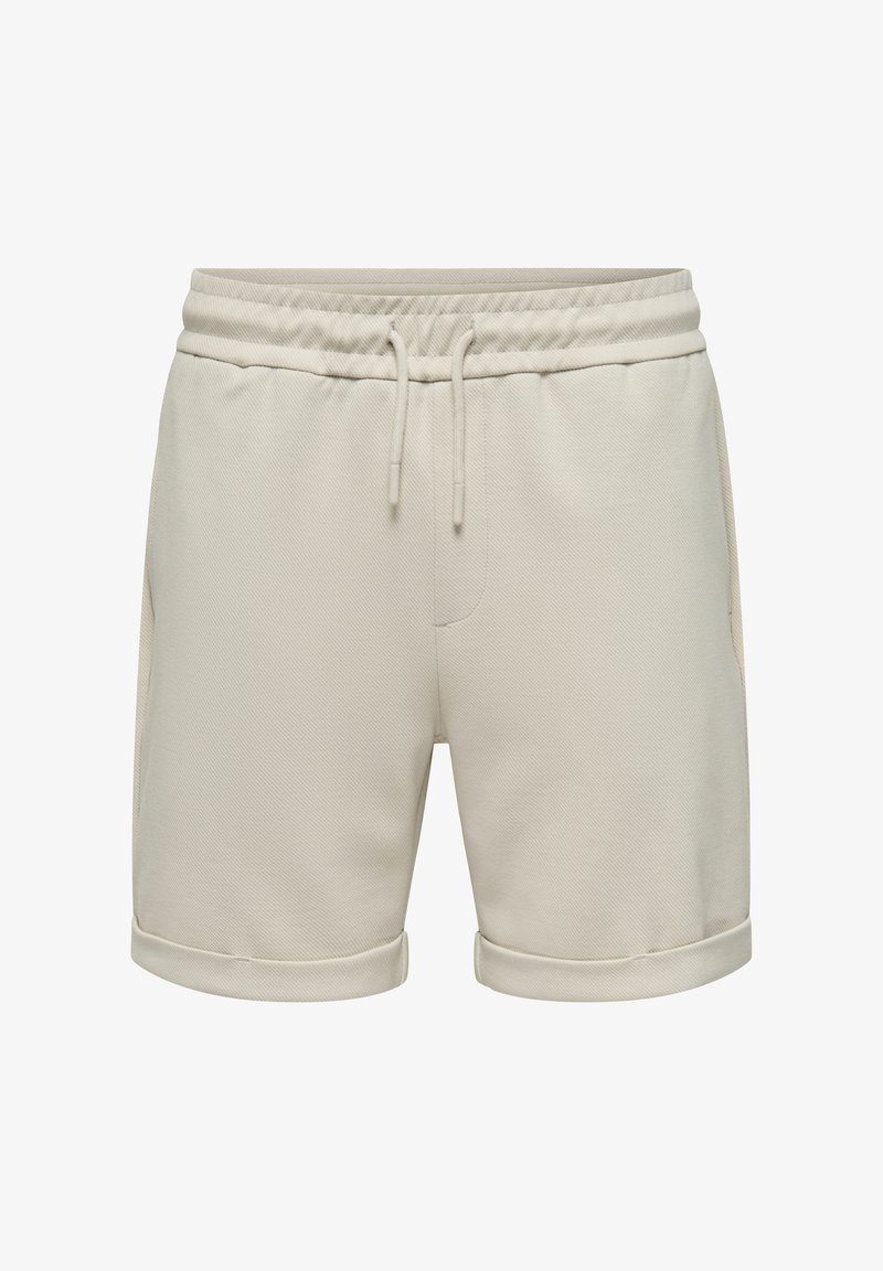 Pantaloncini beige in cotone, con vita elastica e lacci, tasche laterali e bordi arrotolati. Tessuto liscio e testurizzato.