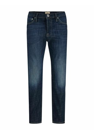 Jeans ajustados de color azul oscuro con un ligero desgaste en los muslos, estilo de cinco bolsillos, cierre de botones y trabillas para cinturón.