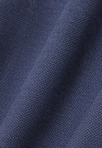 Marineblauer Stoff mit feiner, strukturierter Webart, der Falten und Tiefe zeigt, geeignet für Polsterungen oder Kleidung.