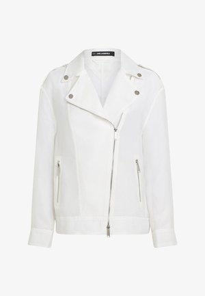 Valge tekstuuriga jakk tõmblukuga, peente horisontaaltriipudega, hõbedaste detailidega ja sälguga kraega. Sisaldab küljetõmblukuga taskuid.