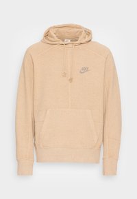 Beige hooded sweatshirt in soft fabric with a kangaroo pocket, drawstring, and a small, silver Nike logo on the chest.