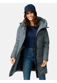 Gray padded long coat with a hood, featuring a zipper and button closure, worn over a navy top and blue jeans.