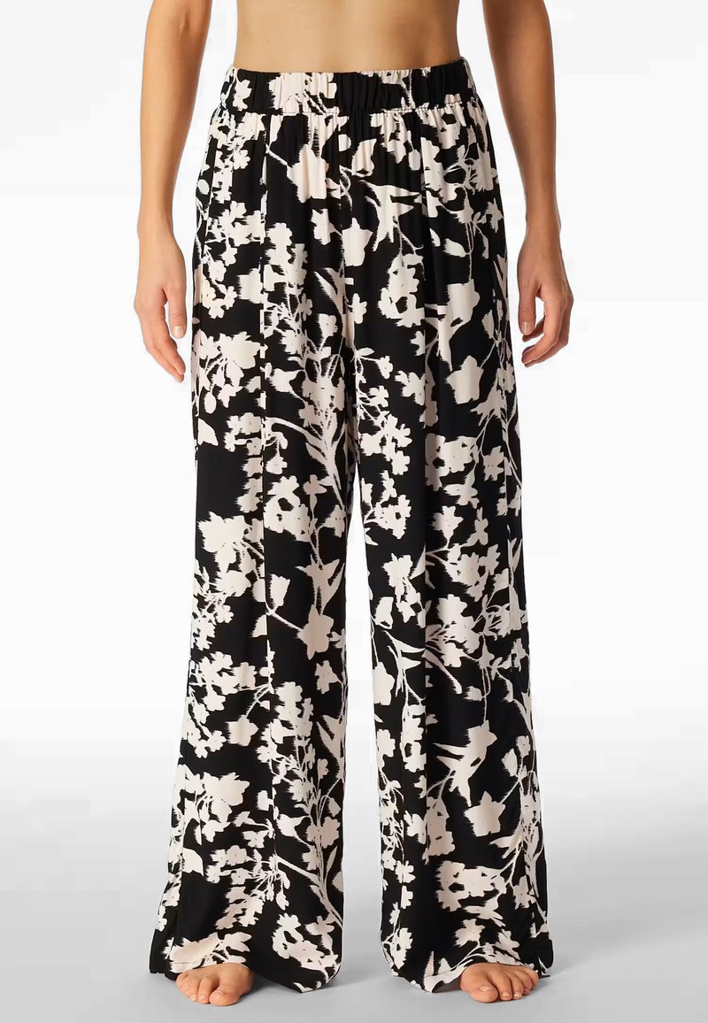 Floral wide-leg pants in black and white, featuring a stretchy waistband and a lightweight, flowy fabric with a soft texture.