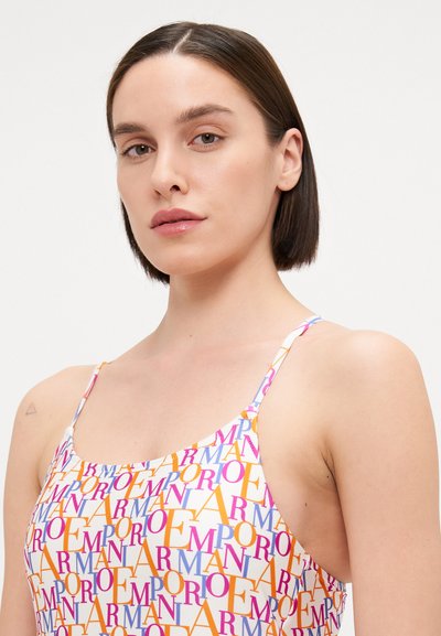 Swimsuit featuring a white background with colorful text patterns in pink, orange, and purple. Thin straps and a fitted design.