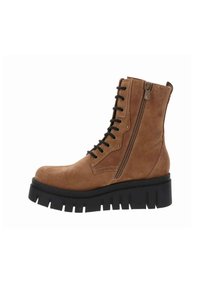 Bottine en suède beige avec semelle épaisse noire, présentant un laçage avant, une fermeture éclair sur le côté et des détails de couture renforcée.