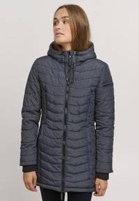 Padded dark gray jacket with a hood, featuring a front zip, side pockets, and ribbed wrist cuffs. Textured fabric with horizontal stitching.