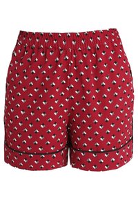 Röda shorts med resår i midjan och ett diamantmönster i svart och vitt, samt svart kant längs fållen.