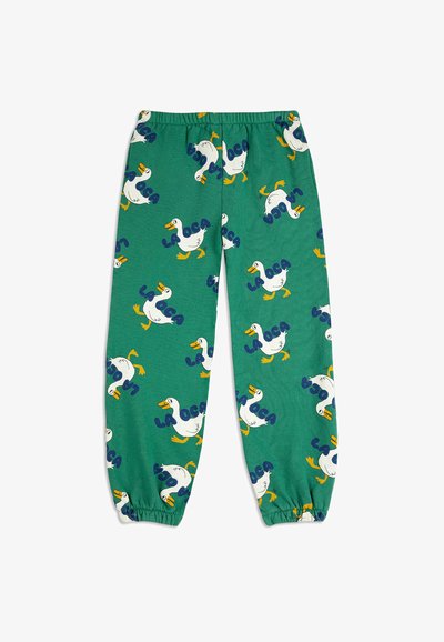 Green cotton pajama pants featuring a pattern of white ducks and blue text "LA OCA." Cuffs at the ankles and an elastic waistband.