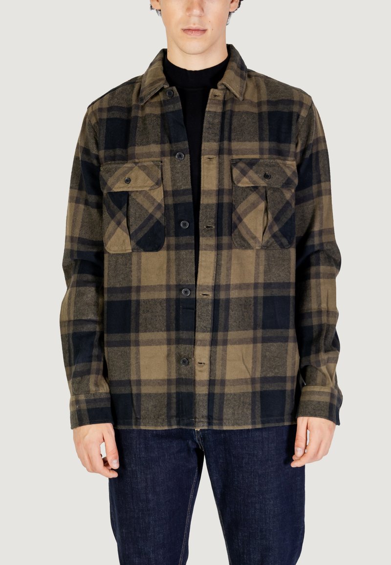 Camicia a quadri con una combinazione di colori verde scuro, nero e beige. Realizzata in tessuto morbido, con due tasche sul petto e chiusura con bottoni.