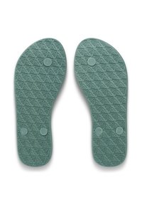 Σκούρες πράσινες εσωτερικές σόλες με υφή και γεωμετρικά σχέδια. Κάθε σόλα έχει ένα 'L' ή 'R' για την αριστερή και δεξιά προσανατολισμό.