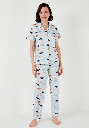 Pajama set made of lightweight cotton, featuring a light blue background with playful multi-colored cat and dog prints; short-sleeved top and long pants.