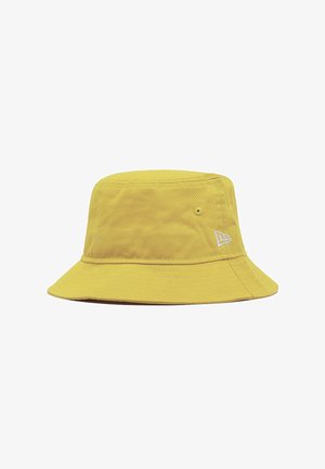 Yellow cotton bucket hat with a wide, downward-sloping brim, featuring a small white logo on the side and a textured fabric surface.