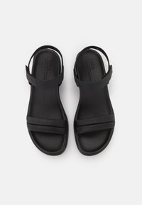 Sandalias negras con dos correas superiores y una correa en el tobillo. Hechas de material suave, cuentan con una plantilla acolchada y un diseño minimalista.