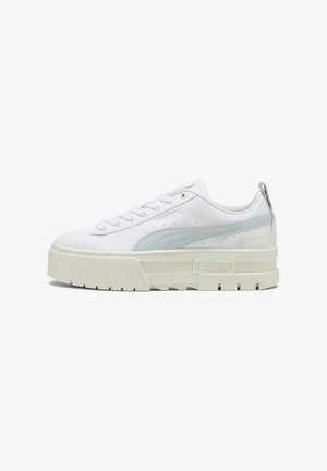 White leather sneakers with light blue accents, thick platform sole, rounded toe, and traditional lace-up design. Puma logo on the side.