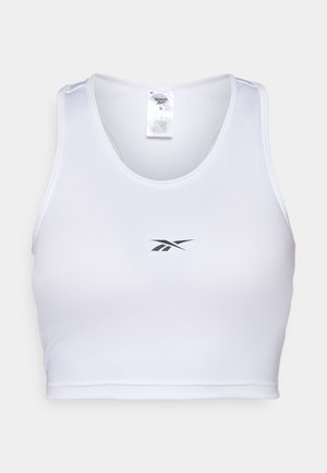 Witte sportieve crop top gemaakt van een soepele stof, met een ronde halslijn en een klein zwart Reebok-logo op de voorkant.