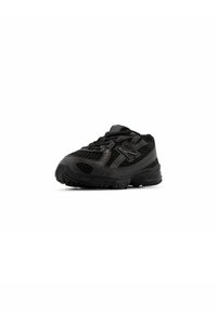 Black athletic shoe with mesh upper, textured accents, and rubber sole. Features rounded toe, lace closure, and logo detail on the side.