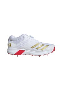White athletic shoe with gold accents, mesh upper, and red sole. Features a textured design, six visible spikes, and a lace-up closure.