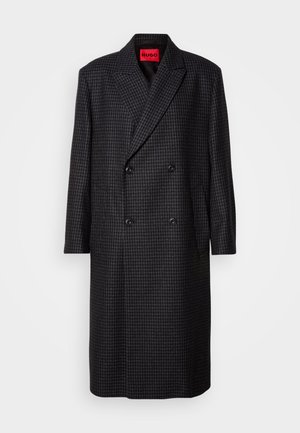 Dark grey houndstooth double-breasted overcoat with black buttons and notched lapels, hanging against a white background.