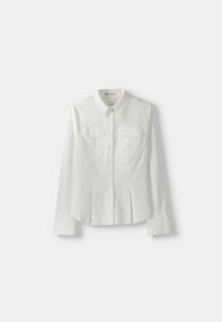 White long-sleeve button-up shirt with vertical stripes, pointed collar, chest flap pockets, and wide cuffs laid flat on white background.