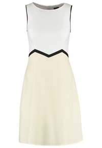 Hihaton mekko, jossa on valkoinen yläosa, vaaleanbeige hame ja mustia yksityiskohtia, joissa on viistokuvio. Sujuva kangas, polvenpituinen leikkaus.