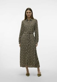 Abito lungo con bottoni realizzato in tessuto stampato nero e beige, caratterizzato da un motivo a rombi e una vita sfiancata con un fiocco.