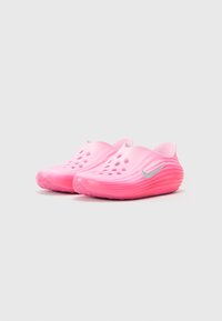 Pink rubber clogs with a smooth surface, side holes for ventilation, and a textured sole, featuring a silver swoosh logo on the side.