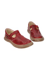 Red leather slip-on shoes with a rounded toe, adjustable strap, and light brown rubber sole. Features contrast stitching and cut-out design.