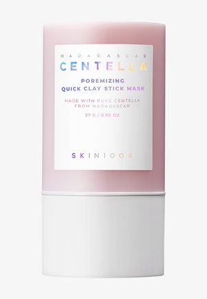 Stavformet beholder for maske med rosa gradient og hvit base. Frontetiketten har tekst om produktet, farget skrift og ingrediensdetaljer.