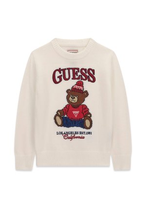 Pull blanc avec un ours en peluche portant un chapeau rouge et un pull, un pantalon bleu, et un texte indiquant "GUESS," "Los Angeles Est. 1981," et "California."