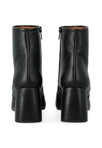 Stivaletti neri in pelle con una finitura testurizzata, dotati di tacco a blocco di altezza media e cerniere laterali per una facile calzata.