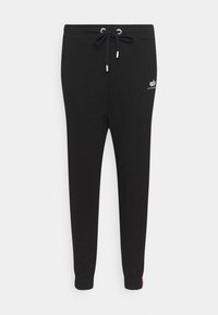 Svarta sweatpants gjorda av en bomullsblandning, med ett elastiskt midjeband med dragsko, avsmalnande ben och en logotypdetalj på sidan.
