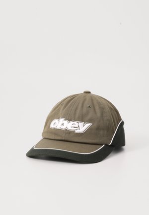 Green cotton baseball cap with a curved visor, featuring a white embroidered "obey" logo and white piping along the brim.