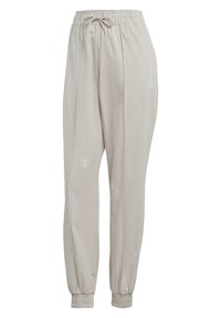 Beiga joggerbyxor med elastisk midja och dragsko. Har broderade detaljer och smalnade muddar vid anklarna.