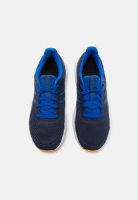 Navy blue athletic shoes with a breathable mesh upper, contrasting blue laces, and white midsole. Features orange outsole for traction.