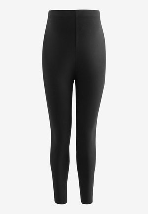 Leggings negros hechos de tela elástica, con una cintura alta, corte ajustado y textura suave. Sin patrones visibles ni detalles de herrajes.