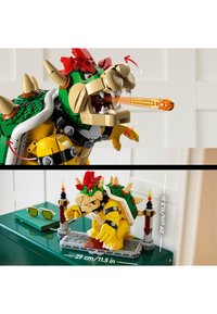 LEGO Bowser figure in green and yellow, with spikes, movable limbs, and flame feature. Includes a display stand and sunglasses. Height: 29 cm.