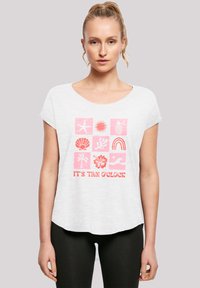 White short-sleeve t-shirt featuring a pink graphic design with tropical icons and the text "IT'S TAN O'CLOCK" at the bottom.