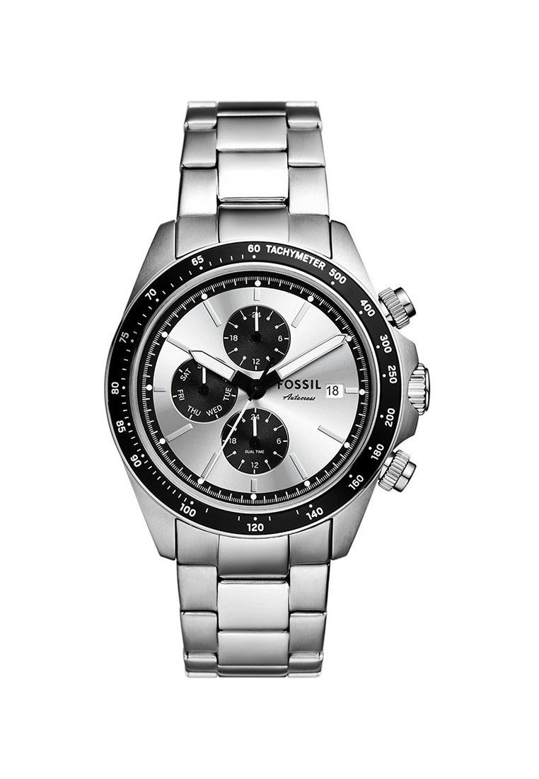 Srebrny zegarek ze stali nierdzewnej z czarną obręczą tachymetryczną, białą tarczą i trzema podtartami. Posiada bransoletę z ogniw oraz koronkę po bokach.