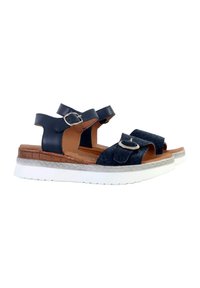 Sandalias azul marino con dos correas de velcro anchas, un detalle de hebilla redonda y un upper texturizado. Suela blanca con un patrón de espiga.