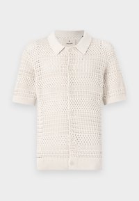 Polo a maniche corte in maglia color beige chiaro con un motivo a trama aperta, dotato di colletto e sei bottoni di chiusura.
