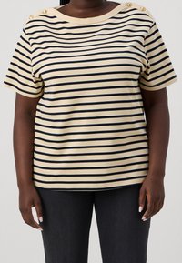 Striped short-sleeve top in beige and navy blue, featuring decorative buttons on the shoulder, made of soft material with a relaxed fit.