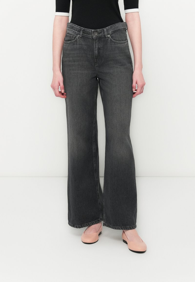Wide-leg gray denim jeans with a slightly faded finish, featuring traditional five-pocket styling and a front button closure.