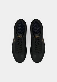 Pair of black Replay sneakers with lace-up design and gold branding on sides and tongue, viewed from above on a white background.