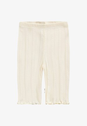 Vaaleakermakuvioiset legginssit, jotka on valmistettu teksturoidusta kankaasta ja joissa on pystysuorat raidat sekä röyhelöhalkio. Kuminauhavyötärö varmistaa istuvuuden.