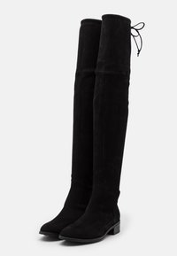 Bottes noires en cuir suédé montant jusqu'au genou, avec un bout arrondi, un talon plat et un lacet ajustable en haut pour un maintien sécurisé.