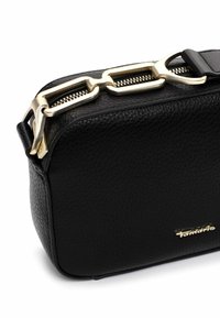Black leather bag with a textured finish, featuring a gold-tone zipper and hardware. Compact rectangular shape with a logo detail visible.